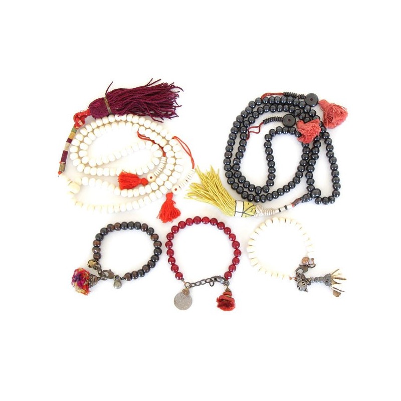 Green and red mala bracelet worn on wrist