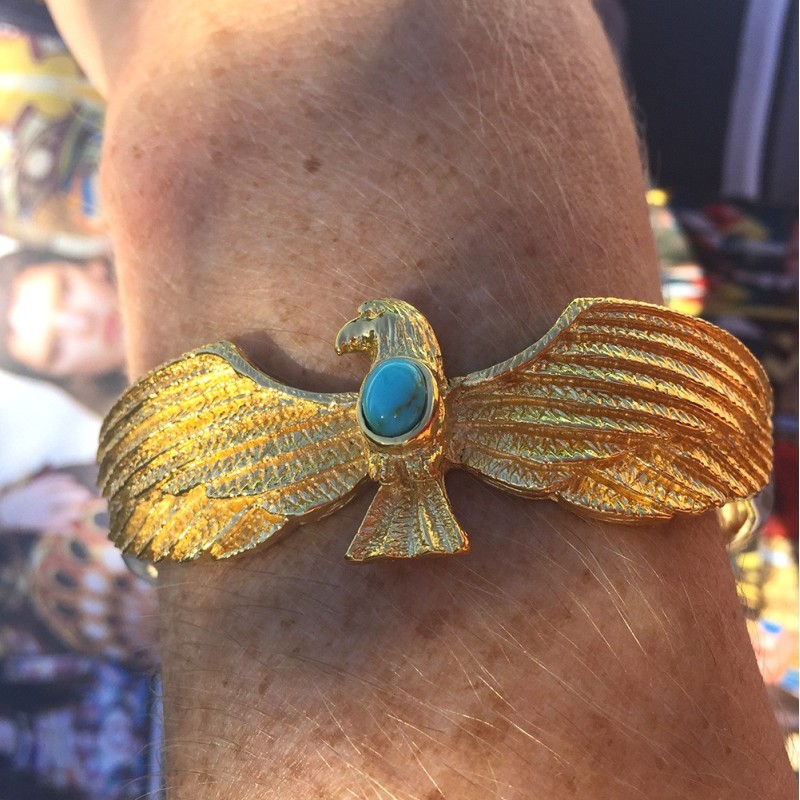 Gold and turquoise eagle bracelet worn on wrist