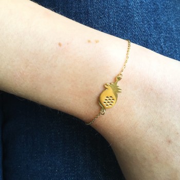 Gold pineapple bracelet worn on wrist