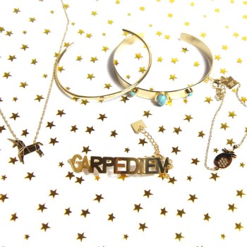 Gold pineapple bracelet layered with other gold bracelets